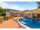 Enjoy the backyard pool and deck, perfect for outdoor entertaining with solar panels on the roof at 106 Contender Dr, Clayton, NC 27520