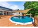 Backyard features above-ground pool with wooden deck and a sunshade, creating an oasis at 106 Contender Dr, Clayton, NC 27520
