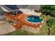 Inviting backyard pool surrounded by wooden deck and shaded by canopy at 106 Contender Dr, Clayton, NC 27520