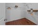 Spacious walk-in closet with wood floors and ample shelving for optimal organization at 106 Contender Dr, Clayton, NC 27520