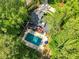 Aerial view of a luxury home with a private pool surrounded by lush greenery at 106 Silverwood Ln, Cary, NC 27518