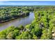 Scenic aerial view of home nestled among trees on a lake at 106 Silverwood Ln, Cary, NC 27518