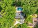 Aerial view of beautiful home with private pool, long driveway, and mature trees at 106 Silverwood Ln, Cary, NC 27518