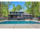 Aerial view of home's backyard featuring in-ground pool, patio, and lush landscaping at 106 Silverwood Ln, Cary, NC 27518