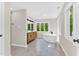 Bright bathroom featuring a modern vanity, freestanding tub, and large windows offering natural light and pleasant views at 106 Silverwood Ln, Cary, NC 27518