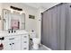 Well-lit bathroom featuring a modern vanity, framed mirror, and shower with gray curtain at 106 Silverwood Ln, Cary, NC 27518