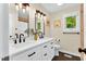 Bright bathroom features a double sink vanity, dark hardware, and framed mirror with accent lighting at 106 Silverwood Ln, Cary, NC 27518