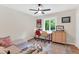 Bedroom featuring a ceiling fan, hardwood floors, a window and a desk with chairs at 106 Silverwood Ln, Cary, NC 27518