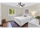 Bright bedroom featuring a white bed, neutral walls, a window and hardwood floors at 106 Silverwood Ln, Cary, NC 27518