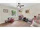Neutral bedroom featuring light hardwood floors, ceiling fan and window letting in natural light at 106 Silverwood Ln, Cary, NC 27518