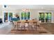 Bright dining room with large windows, stylish decor, and easy access to the outdoor deck for entertaining at 106 Silverwood Ln, Cary, NC 27518