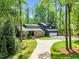 Beautiful two-story home with stone accents, manicured lawn, and a long driveway at 106 Silverwood Ln, Cary, NC 27518