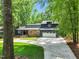 Charming home with stone accents, well-maintained landscaping, and a spacious driveway at 106 Silverwood Ln, Cary, NC 27518