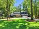 Well-manicured lawn and mature trees frame this spacious home with stone accents at 106 Silverwood Ln, Cary, NC 27518