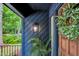 Inviting entryway with a wooden door, stylish wreath, and a charming exterior light at 106 Silverwood Ln, Cary, NC 27518