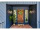 Cozy entryway with a wooden door, accent plants, and warm ambient lighting at 106 Silverwood Ln, Cary, NC 27518