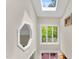 Bright hallway with skylight, large window, and decorative mirror at 106 Silverwood Ln, Cary, NC 27518