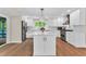 Modern kitchen with white cabinetry, stainless steel appliances, and a center island perfect for meal preparation at 106 Silverwood Ln, Cary, NC 27518