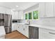 Bright kitchen features white cabinets, stainless steel appliances, and a window at 106 Silverwood Ln, Cary, NC 27518