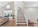 Bright living room features a soaring ceiling, wood-look staircase and hardwood floors at 106 Silverwood Ln, Cary, NC 27518