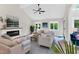 Inviting living room with a cozy fireplace, large windows, and stylish seating, creating a warm ambiance at 106 Silverwood Ln, Cary, NC 27518