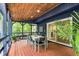 Charming screened outdoor dining space with view to a serene backyard with lush trees at 106 Silverwood Ln, Cary, NC 27518