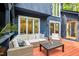 Relaxing outdoor seating area on wooden deck with a cozy cushioned sectional sofa and a coffee table at 106 Silverwood Ln, Cary, NC 27518