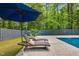 Secluded pool area with lounge chairs and umbrella, offering a peaceful outdoor retreat at 106 Silverwood Ln, Cary, NC 27518