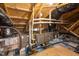 View of the attic, showing construction with beams, pipes and an HVAC system at 109 Imagine Way, Pittsboro, NC 27312