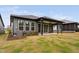 Backyard featuring an AC unit, flower bed, and covered porch with ceiling fans at 109 Imagine Way, Pittsboro, NC 27312