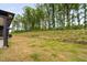 Exterior backyard view showcasing lush green trees and the edge of the home at 109 Imagine Way, Pittsboro, NC 27312