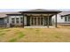 Backyard featuring a covered porch with ceiling fans, flower bed, and AC unit at 109 Imagine Way, Pittsboro, NC 27312