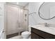 Bathroom featuring a glass shower, toilet, vanity, and round mirror at 109 Imagine Way, Pittsboro, NC 27312