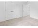Bedroom with neutral carpet, baseboard molding, and several white doors at 109 Imagine Way, Pittsboro, NC 27312