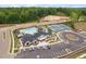 Aerial view of community clubhouse, pool, and tennis courts with well-maintained parking at 109 Imagine Way, Pittsboro, NC 27312