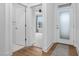 Bright entryway showcasing wood floors, white trim, a glass paneled door, and an open view into the home at 109 Imagine Way, Pittsboro, NC 27312