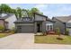 Inviting gray home featuring a two car garage, professionally landscaped front yard, and modern design at 109 Imagine Way, Pittsboro, NC 27312