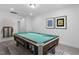 Spacious game room with carpet and pool table, with modern art hung on the wall at 109 Imagine Way, Pittsboro, NC 27312