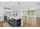 Open concept kitchen and living area with large island and sliding doors at 109 Imagine Way, Pittsboro, NC 27312