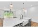 Open concept kitchen with island and eat in bar, and open to the living room at 109 Imagine Way, Pittsboro, NC 27312