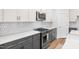 Kitchen features stainless steel appliances, white cabinets, and mosaic backsplash at 109 Imagine Way, Pittsboro, NC 27312