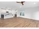 Spacious open floor plan with wood floors extends from the living area into the kitchen featuring white cabinets at 109 Imagine Way, Pittsboro, NC 27312
