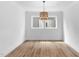 Bright, open living room featuring hardwood floors, two windows, and a stylish woven light fixture at 109 Imagine Way, Pittsboro, NC 27312