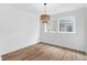Bright, open living room featuring hardwood floors, two windows, and a stylish woven light fixture at 109 Imagine Way, Pittsboro, NC 27312