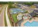 Aerial of community tennis courts, putting green, hot tub, and pool amenities, and well-manicured landscaping at 109 Imagine Way, Pittsboro, NC 27312