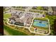 Aerial view of community clubhouse, tennis courts, bocce ball, and lush landscaping at 1121 Coast Grade St, Wake Forest, NC 27587