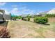 View of a spacious, grassy backyard featuring a patio with furniture and manicured landscaping at 1121 Coast Grade St, Wake Forest, NC 27587