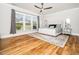 Sun-filled bedroom with hardwood floors, a ceiling fan, and a serene view at 1121 Coast Grade St, Wake Forest, NC 27587