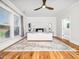 Bright bedroom features large windows, decorative rug, and ceiling fan at 1121 Coast Grade St, Wake Forest, NC 27587