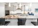 A granite island takes prominence in the kitchen with barstool seating and pendant lights above at 1121 Coast Grade St, Wake Forest, NC 27587